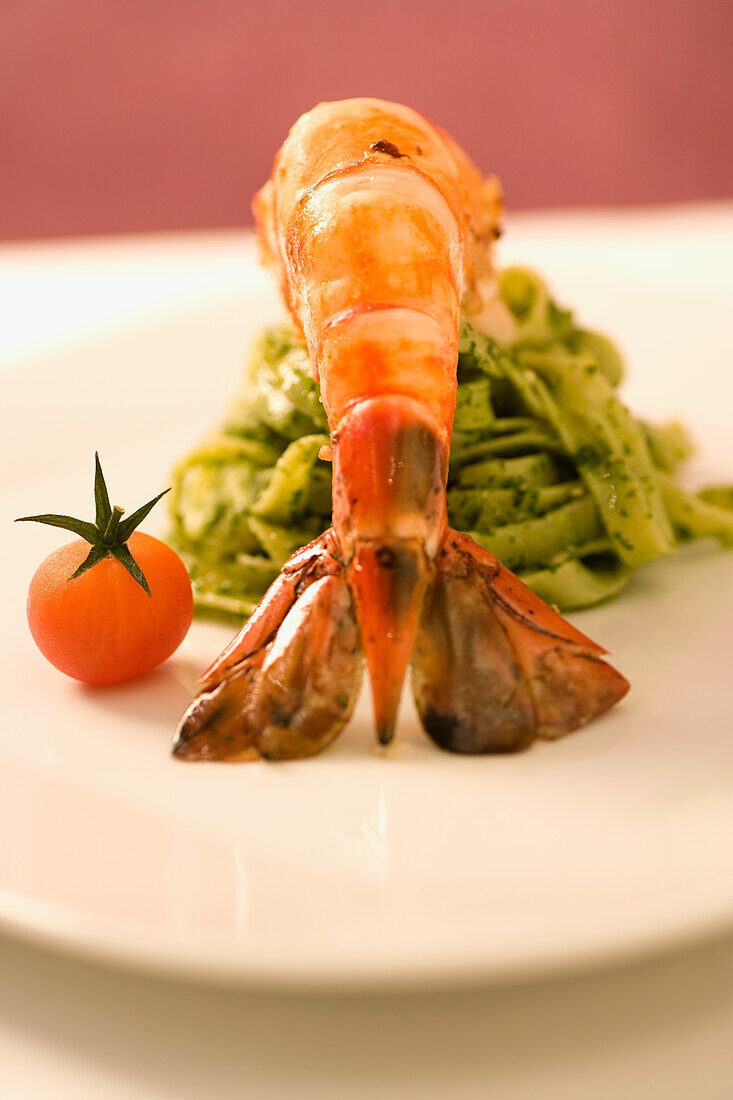 Ribbon noodles with pesto and grilled king prawns