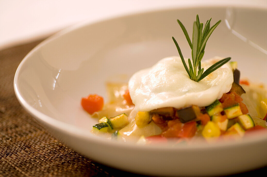 Vegetable ragout with poached egg and rosemary