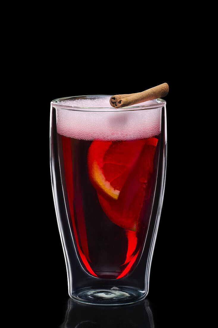 Mulled wine with orange slices and cinnamon stick