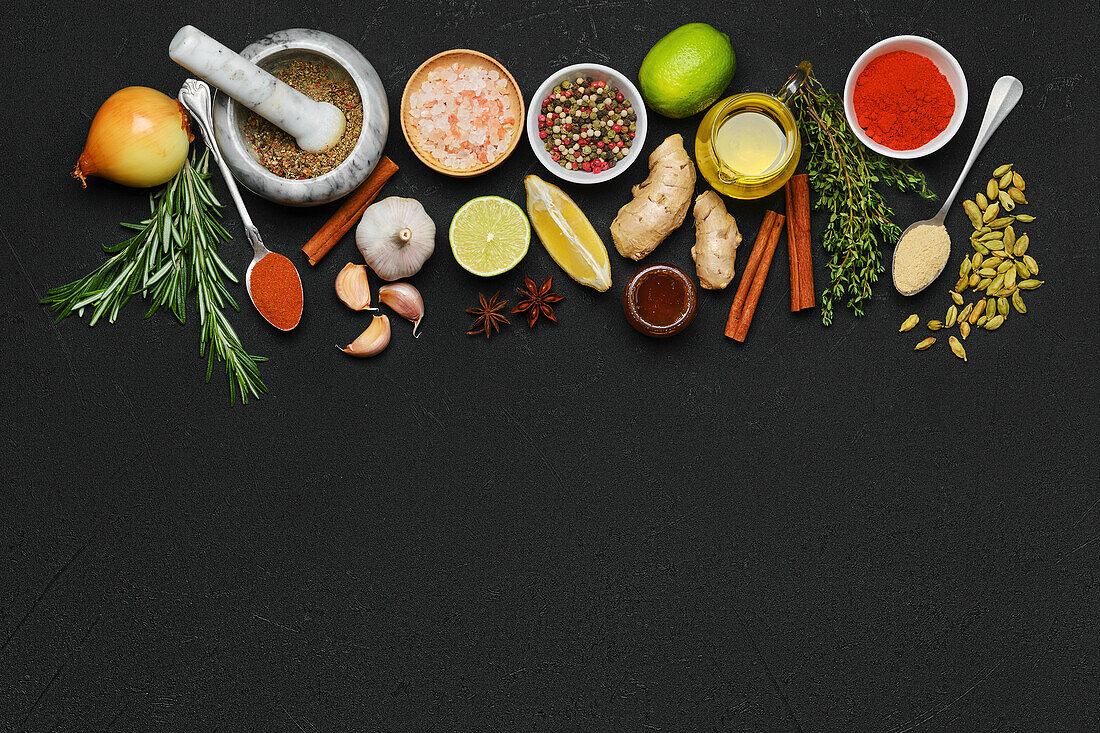 Various spices and herbs on a black background