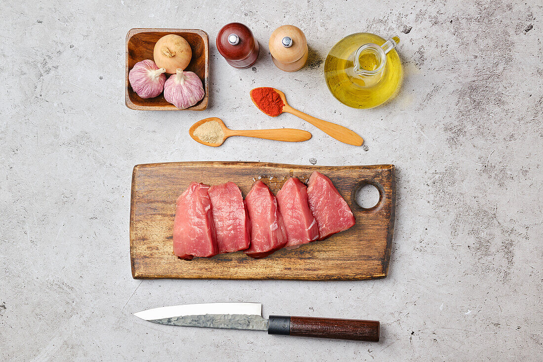 Raw pork steaks with garlic and spices