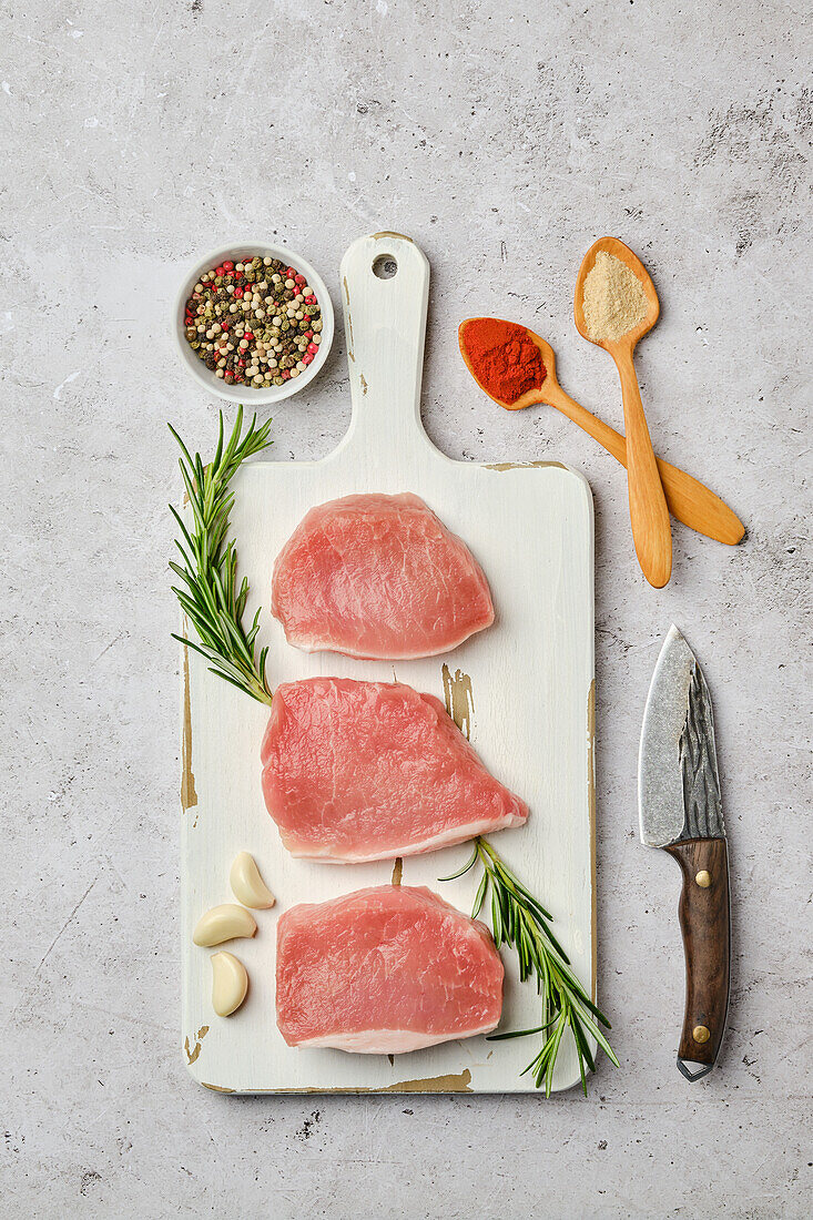 Raw pork chops with rosemary and spices