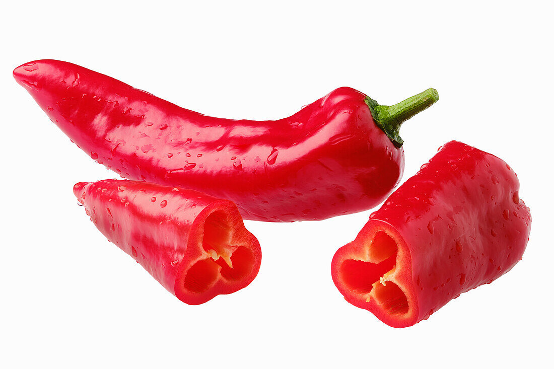 Whole and halved red peppers (capia)