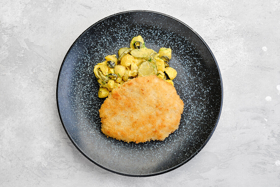 Pork schnitzel with potato and cucumber salad