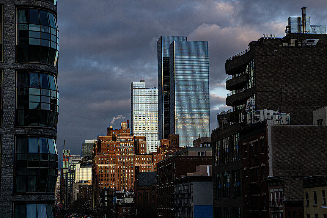 Cityscape with dramatic sky, view looking north from Chelsea neighborhood, New York City, New York, USA