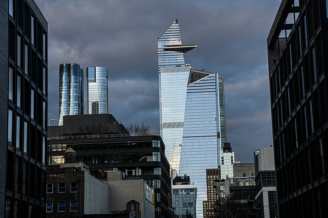 Cityscape with dramatic sky, view looking north from Chelsea neighborhood to 10 Hudson Yards and 30 Hudson Yards, New York City, New York, USA