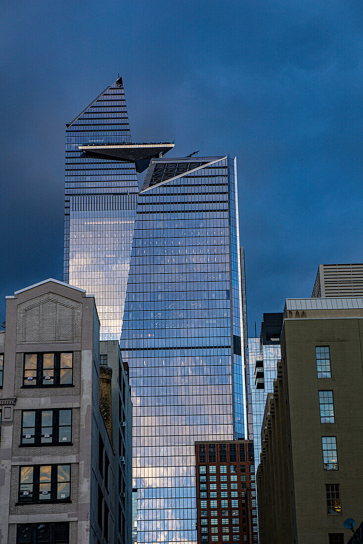 Cityscape with dramatic sky, view looking north from Chelsea neighborhood to 10 Hudson Yards and 30 Hudson Yards, New York City, New York, USA