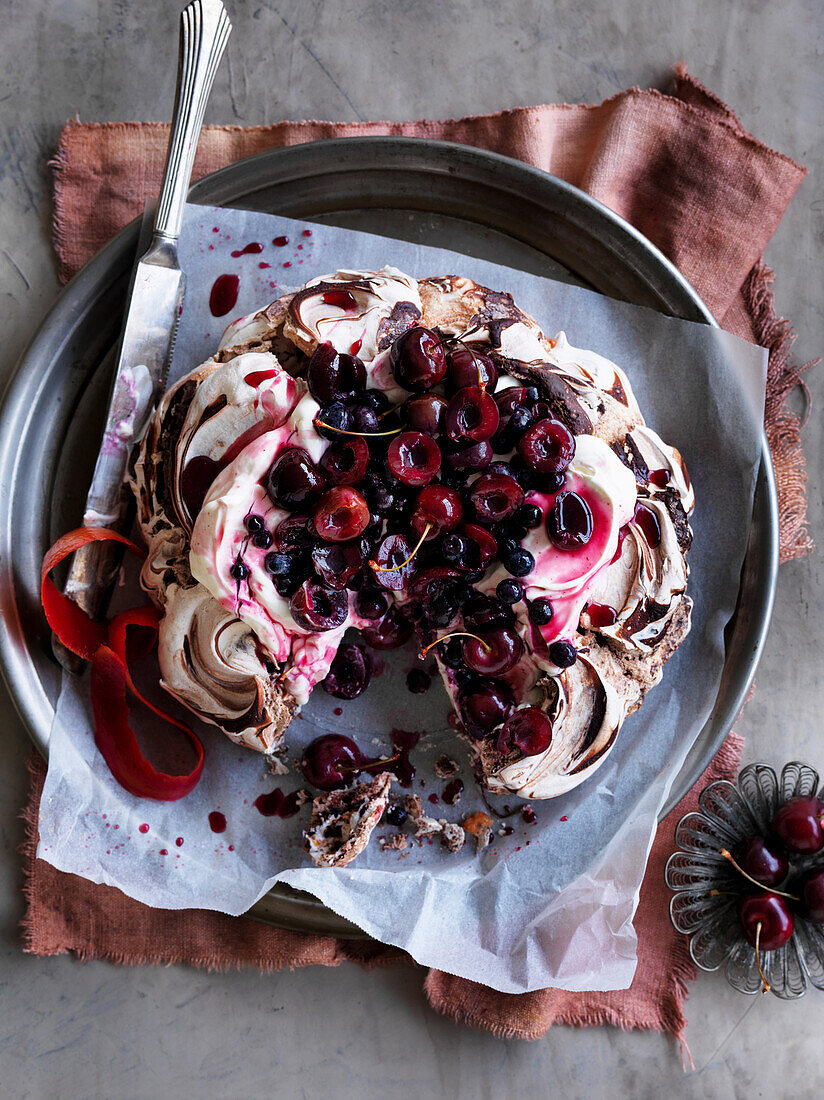 Chocolate pavlova with cherries and berries