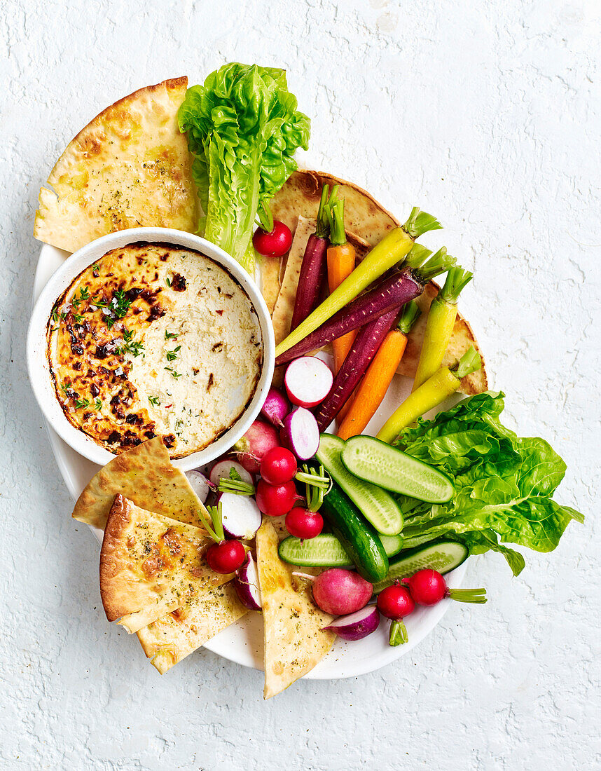 Baked herb ricotta dip with vegetable sticks