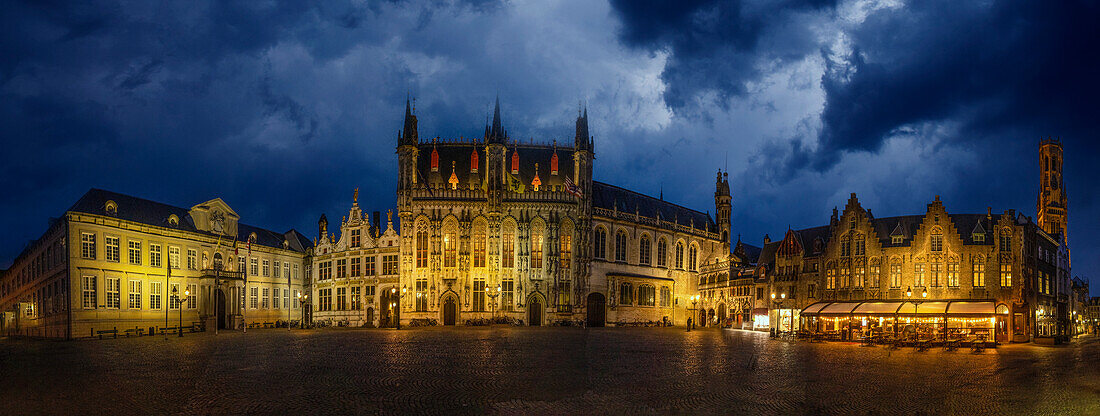 Belgium, Brugge. Panoramic of medieval architecture and square at night.