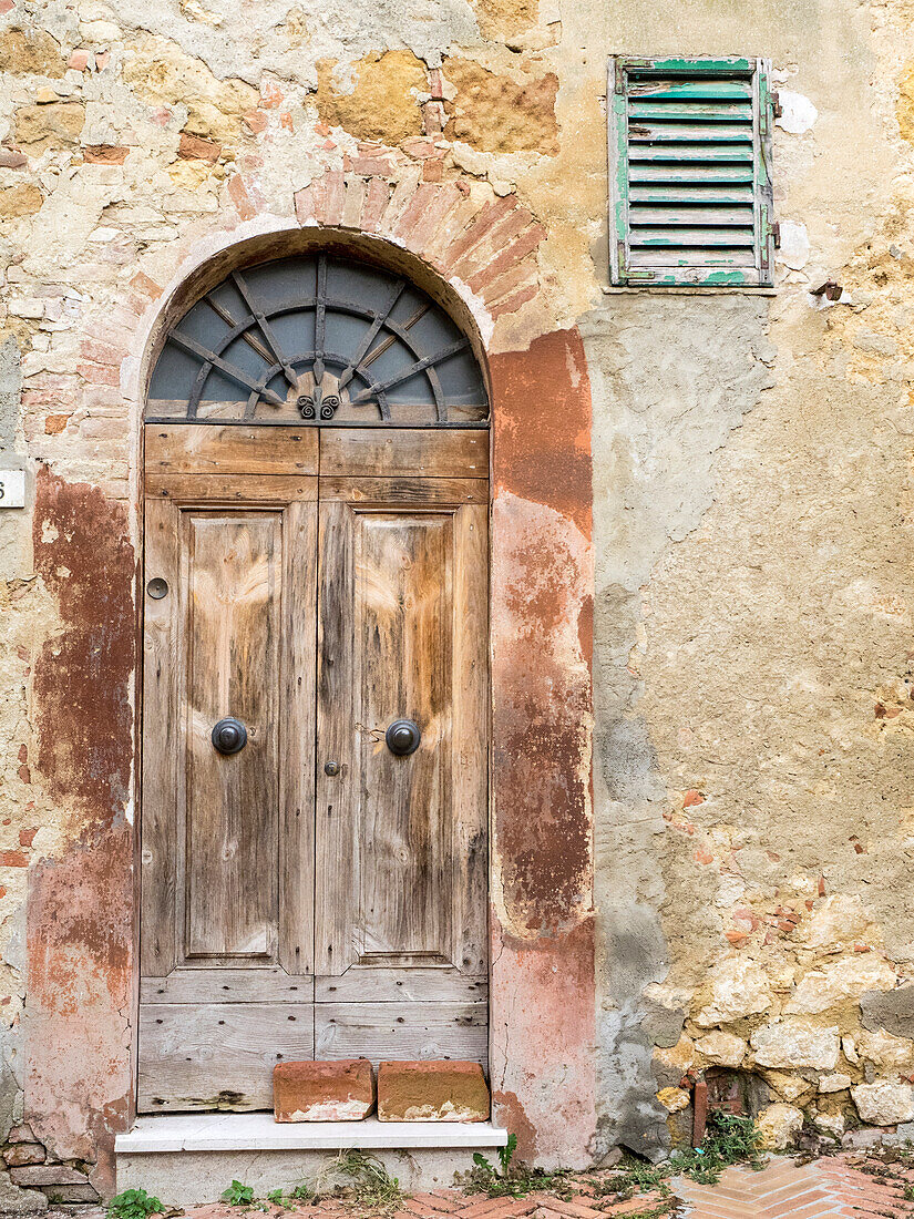 Italy, Tuscany, Pienza. Old wooden door along the streets.