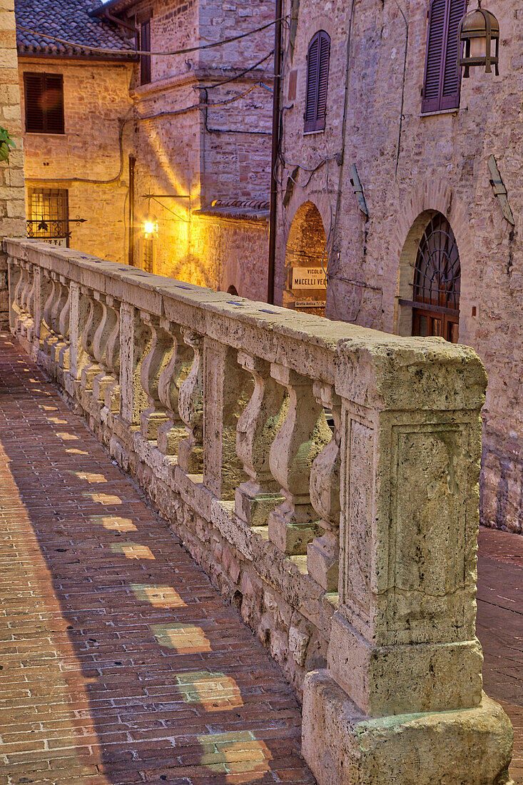 Italy, Umbria, Assisi. Short stone wall with columns near the Convento Chiesa Nuova.