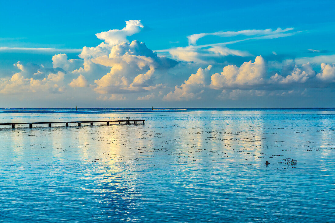 Rain storm reflection, Moorea, Tahiti, French Polynesia. Different blue colors in water in lagoon and coral reefs