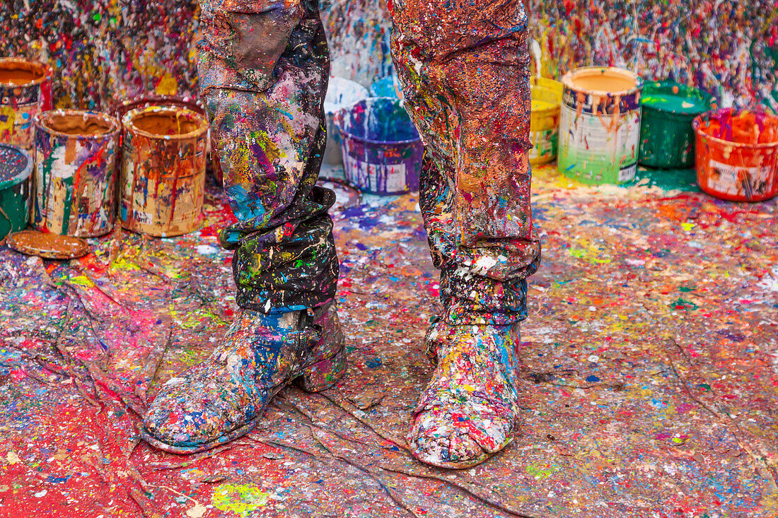 Argentina, Buenos Aires. Colorful paint spatters on artist's boots.
