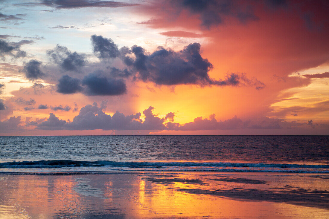 USA, Georgia, Tybee Island. Sunrise with reflections and clouds.