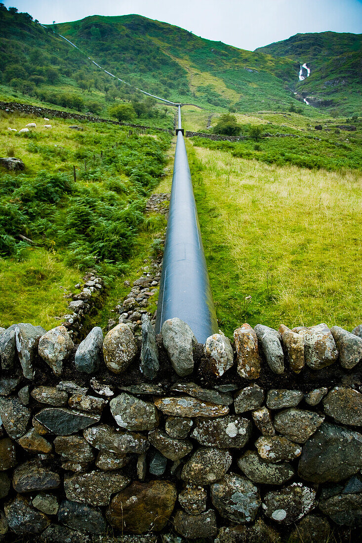 Giant pipe work traveling down hill from reservoir for Hydro-Electric Power Plant, Snowdonia National Park; Nant Gwynant, North Wales