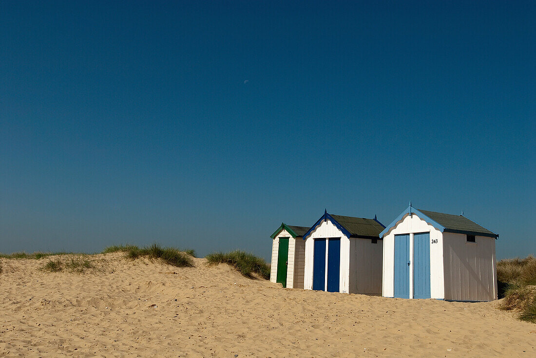 Traditional beach huts in the sand dunes at Southwold, Suffolk, UK