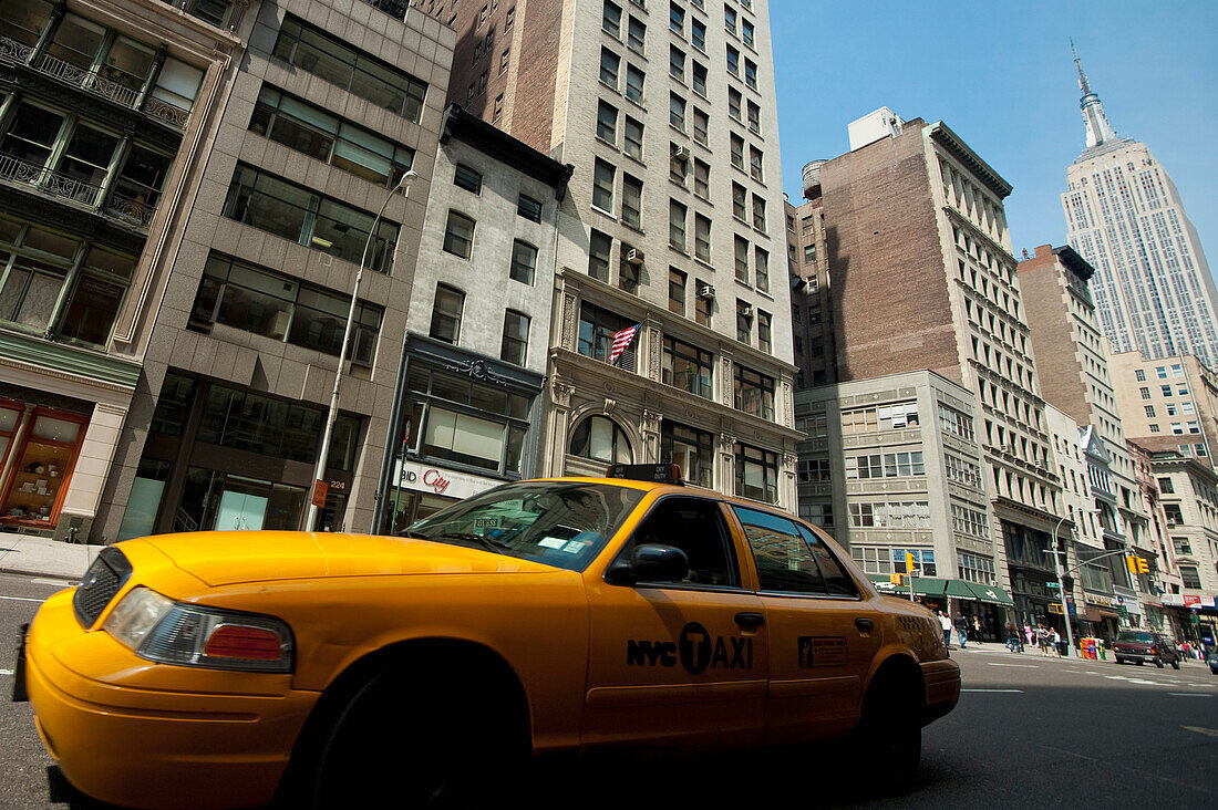 Taxi fährt vor dem Empire State Building vorbei, Manhattan, New York, USA