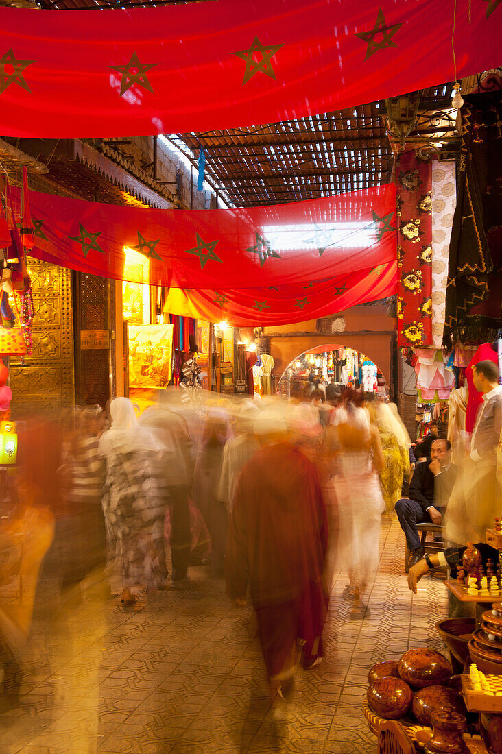 Morocco, People walking on street at night; Marrakesh