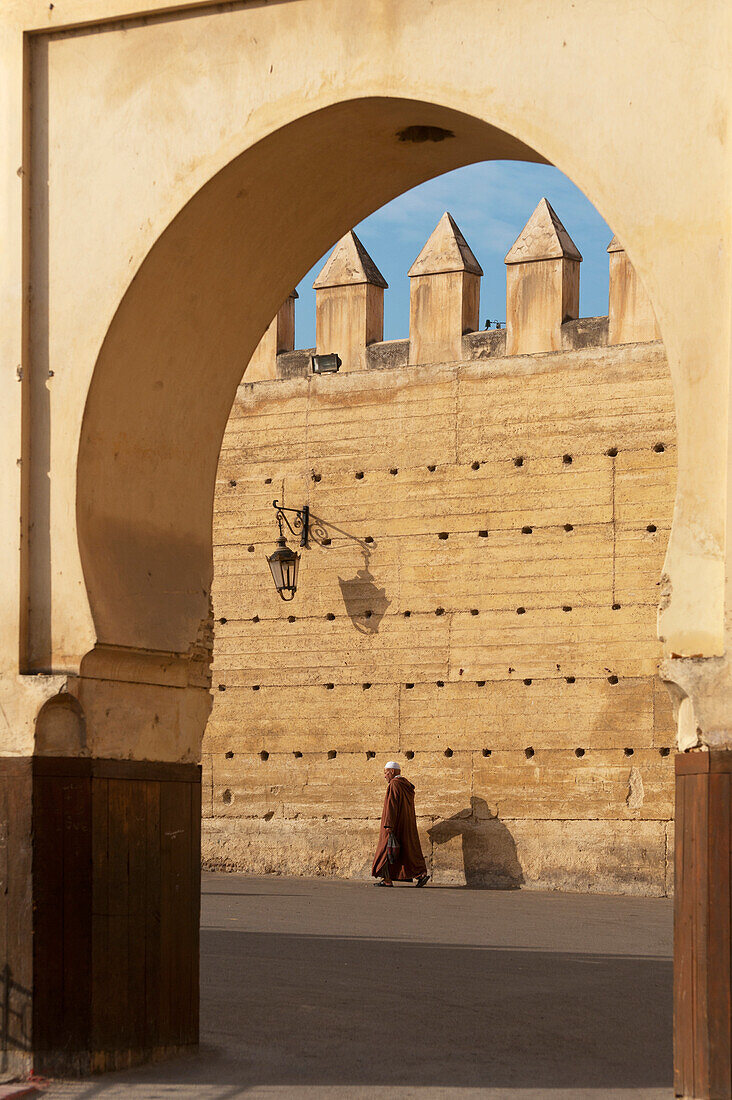 Morocco, Man walking on street near Royal Palace; Fez
