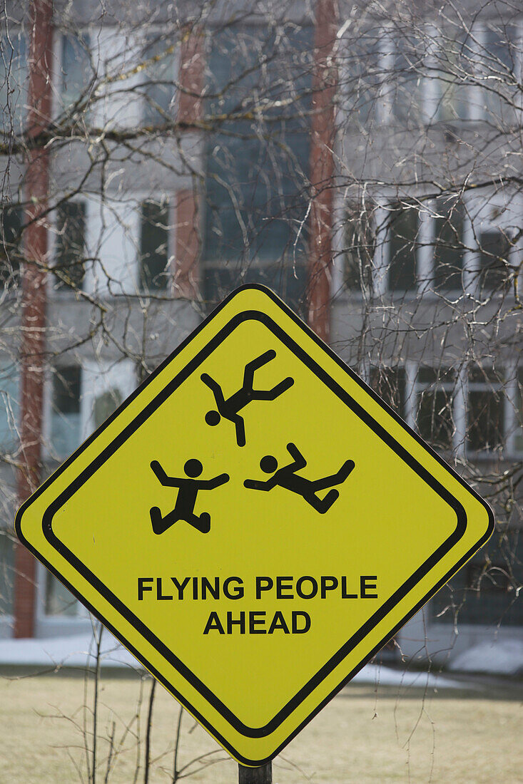 Ein humorvolles Schild, das fliegende Menschen zeigt; Riga, Lettland