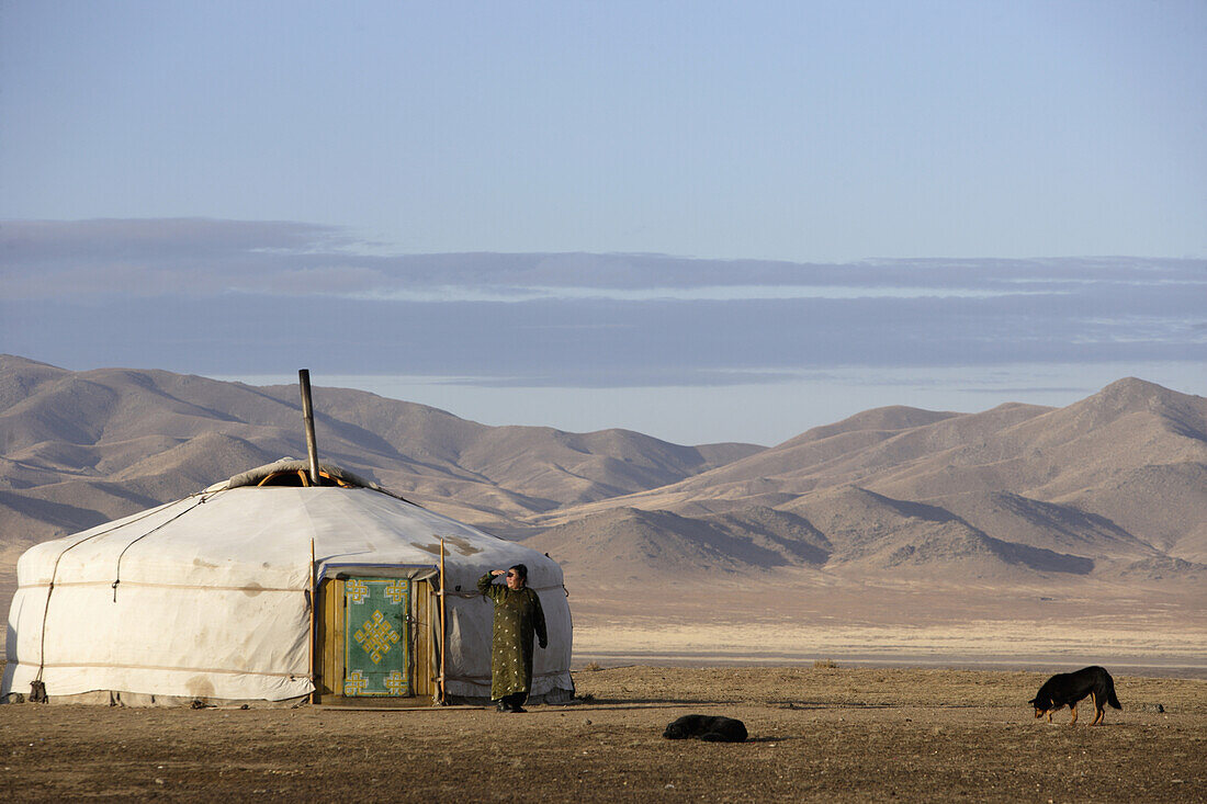 A woman in front of a yurt; Kharkhorin, Mongolia
