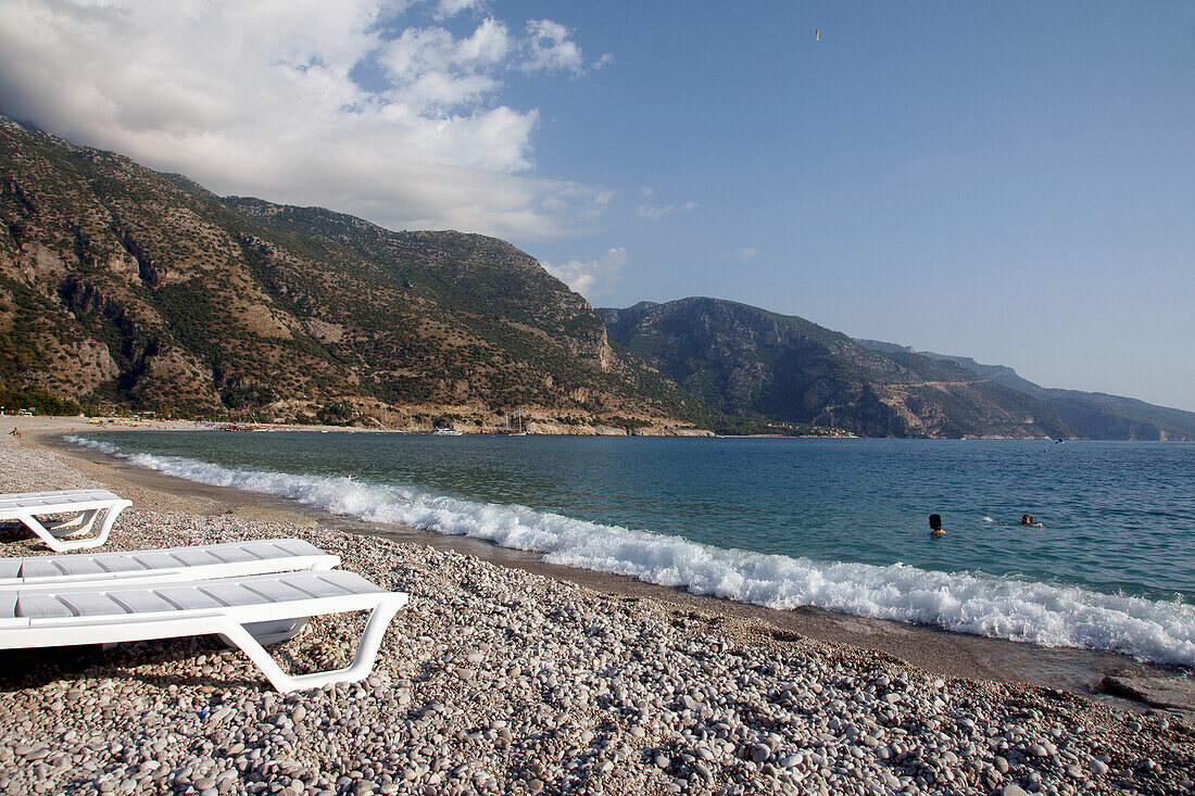 Abandoned Sun Loungers On A Pebbly Beach, The National Park, Oludeniz At The Turquoise Coast, Southern Turkey