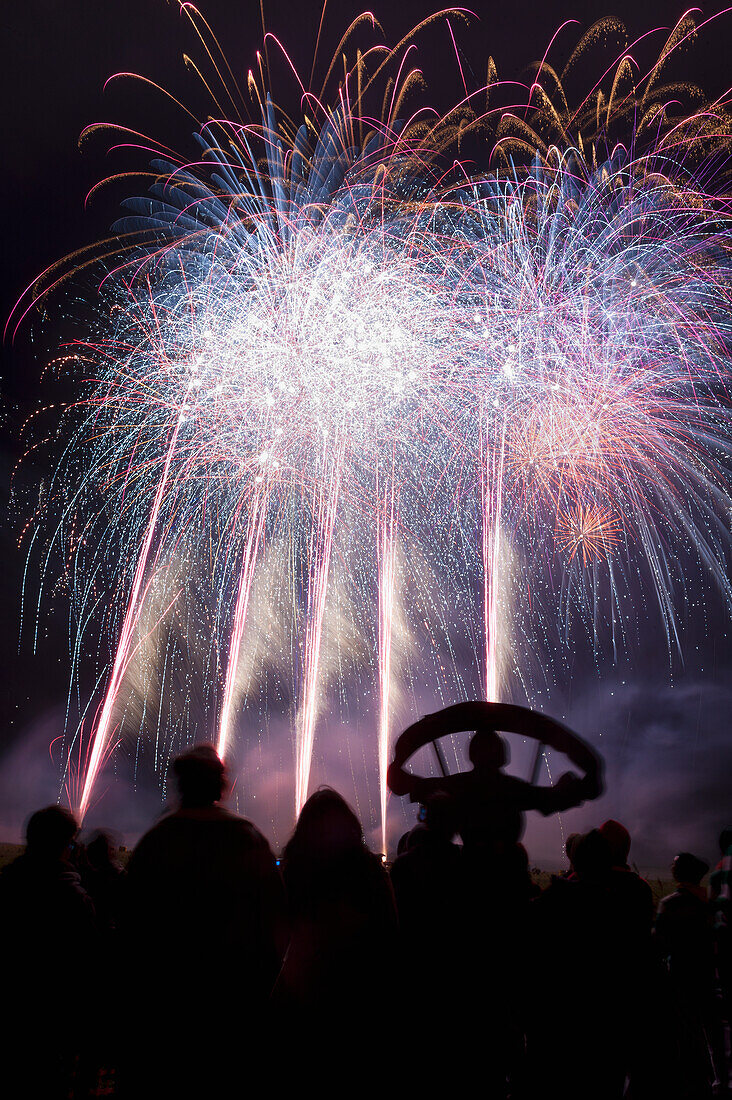 People From Southover Bonfire Society Watch The Fireworks On Bonfire Night, Lewes, East Sussex, Uk