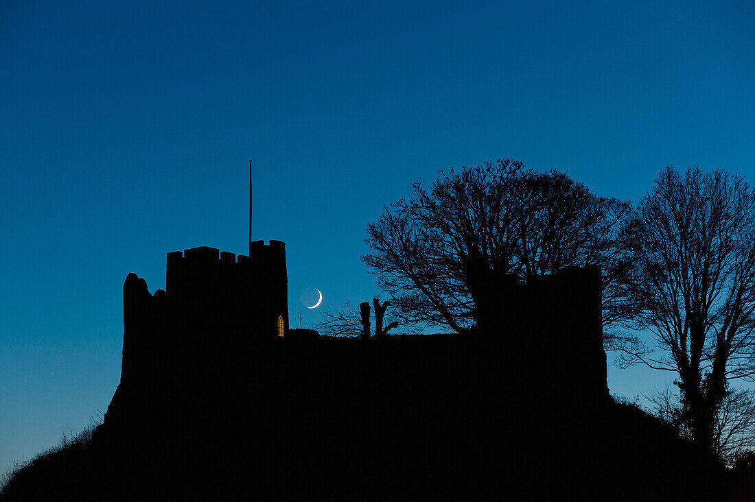 Crescent Moon Setting Behind Silhouette Of Lewes Castle, Lewes, East Sussex, Uk