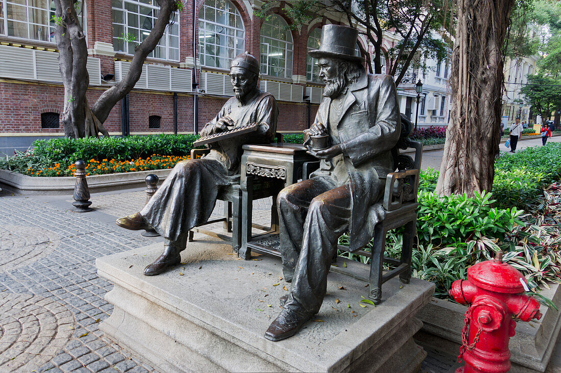 China, Guangdong, Shamian Island; Guangzhou, Statues on bench