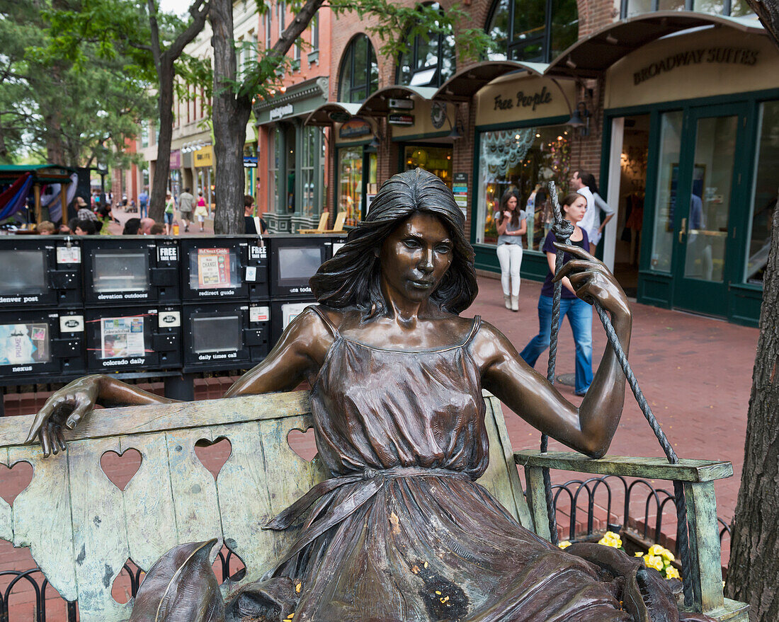 USA, Colorado, Pearl Street bronze sculpture and Hearts on swing by George Lundeen; Boulder