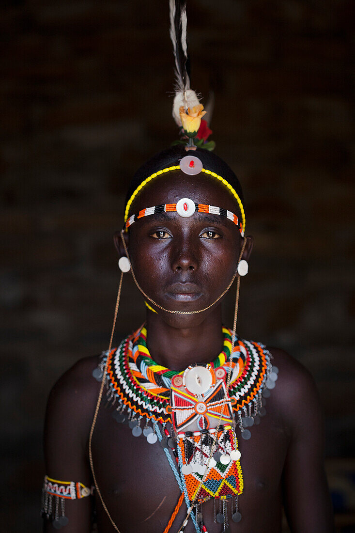 Kenya, Portrait of young Samburu man (Moran) in traditional dress; South Horr