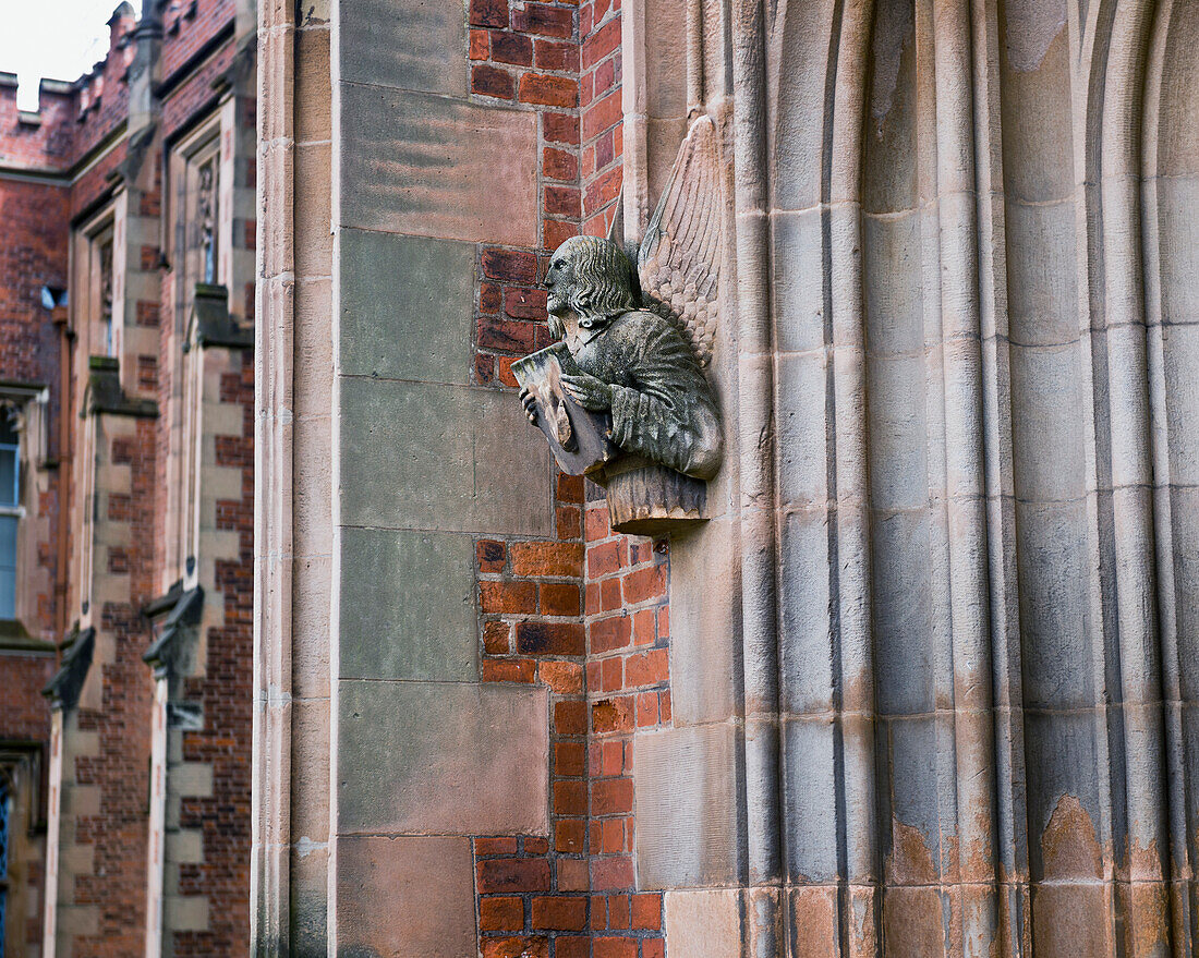 United Kingdom, Northern Ireland, Stone angel figure on facade of Queens University Library; Belfast