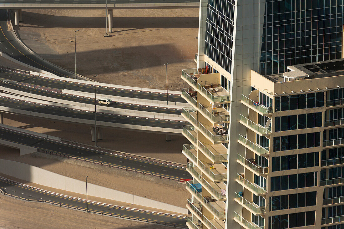 UAE, Residential block of flats in front of large road junction; Dubai