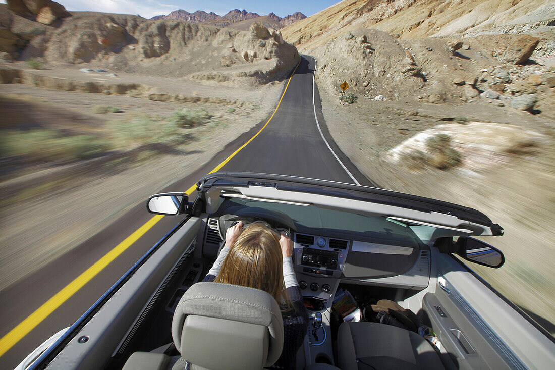 Usa, California, Young Woman Driving Convertible Car; Death Valley National Park
