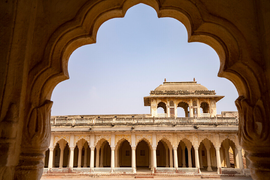 Arched view to the colonnaded walkway and inner courtyard in Ahhichatragarh Fort (Nagaur Fort); Nagaur, Rajasthan, India