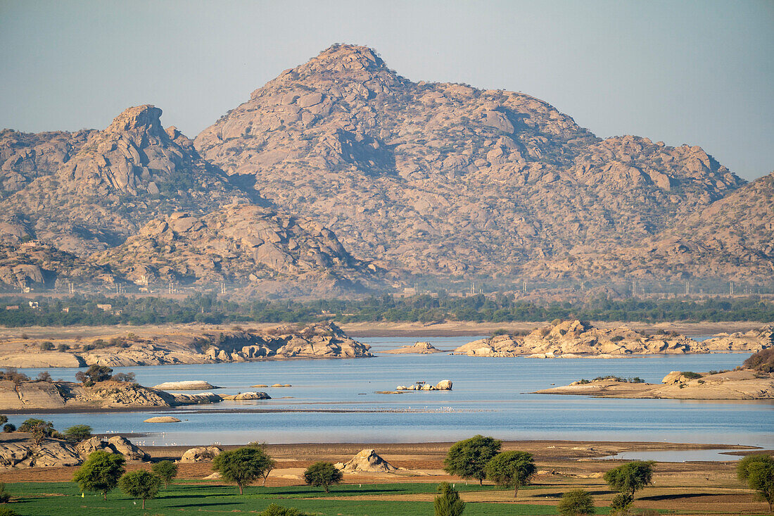 The landscape of a dam lake and the desert with the rocky Aravali Hills in the Pali Plain of Rajasthan; Rajasthan, India