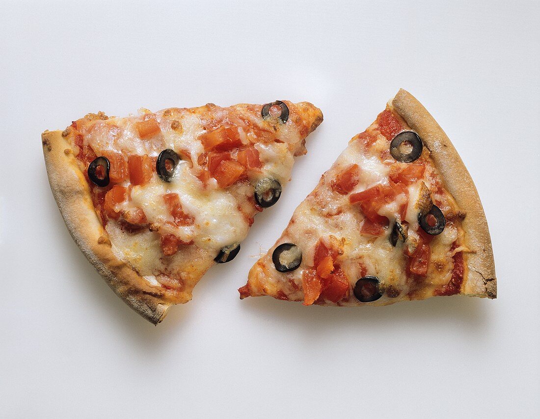 Two pieces of pizza with tomato, cheese and olives