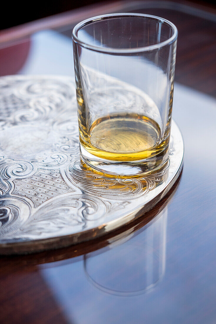 A glass of Scottish whisky rests on a table during a tasting; Fort Augustus, Scotland
