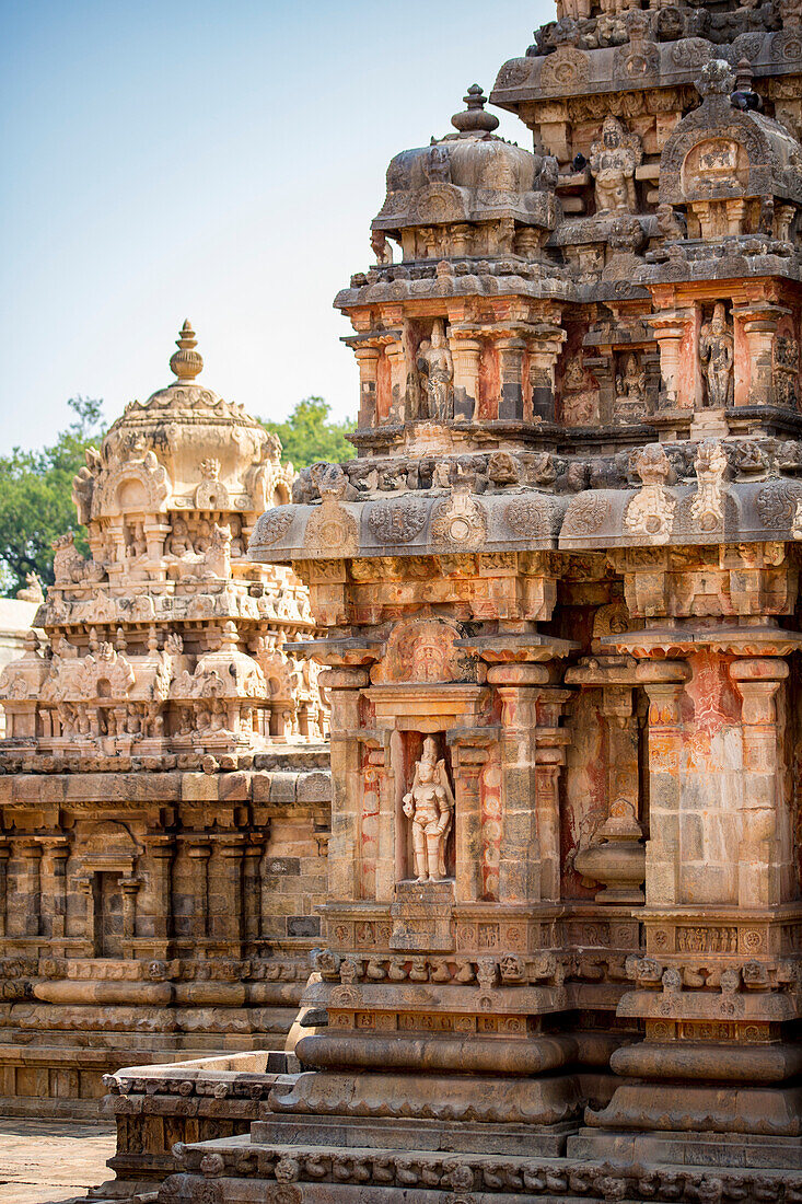 Temple structures, alcove with Hindu deity carving in stone wall of Dravidian Chola era Airavatesvara Temple; Darasuram, Tamil Nadu, India