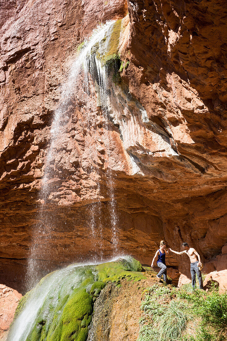 Two hikers descend from Ribbon Falls off North Kaibab Trail.; Grand Canyon National Park, Arizona