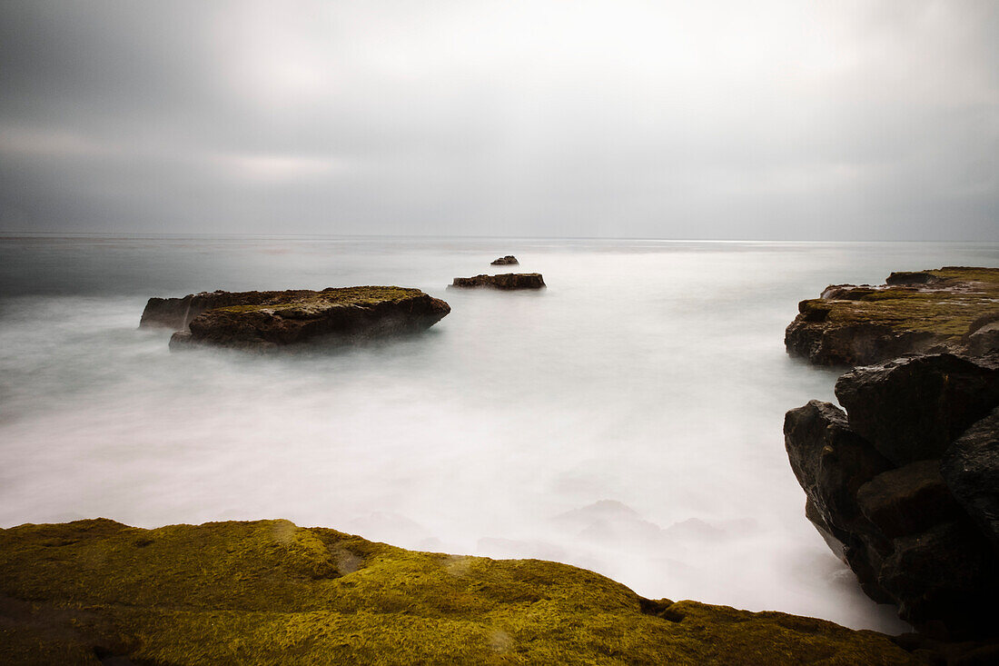 A long exposure seascape made along a rocky beach in Santa Cruz; Santa Cruz, California, United States of America