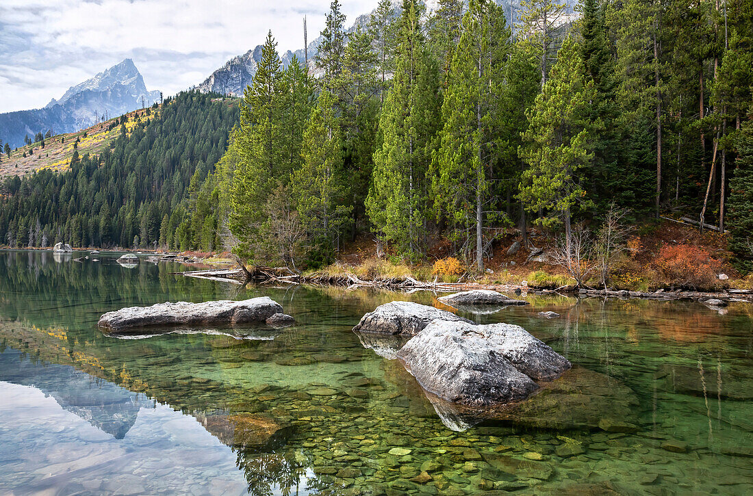 Teton Mountain Range reflected in the crystal clear, String Lake in Grand Teton National Park; Wyoming, United States of America