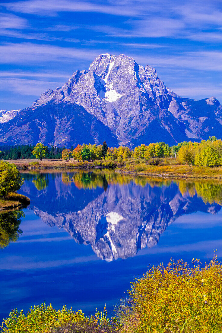 Mount Moran of the Grand Tetons reflected in Snake River in Grand Teton National Park in autumn; Wyoming, United States of America