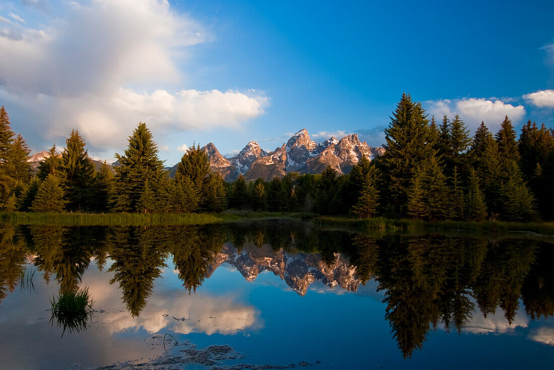 The Grand Tetons reflected in Snake River in Grand Teton National Park; Wyoming, United States of America