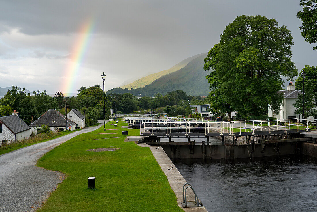 A rainbow stretches across the sky over Neptune's Staircase along the Caledonian Canal near Corpach, Scotland; Corpach, Scotland