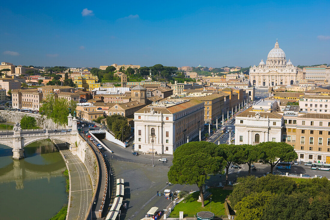 Overview of Vatican City with the iconic St Peter's Basilica in the background along the Tiber River at Ponte Vittorio Emanuele II bridge; Rome, Lazio, Italy