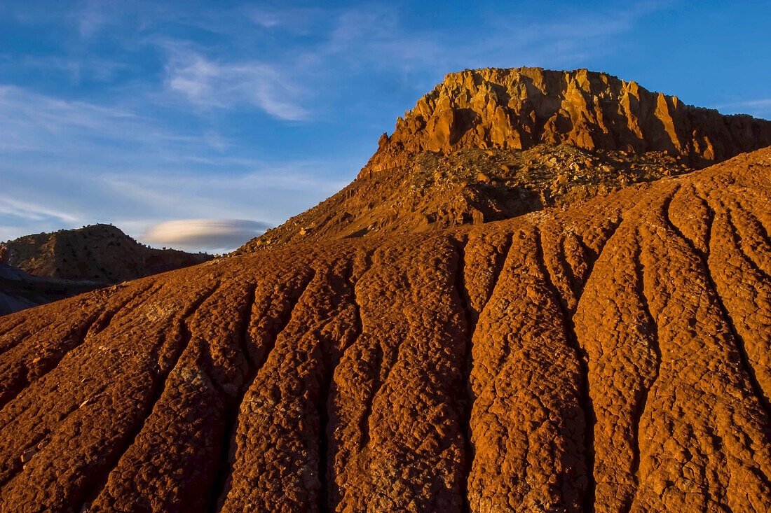 A red sandstone canyon in New Mexico is surrounded by a blue sky.