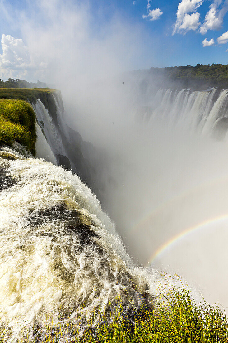 A rainbow in the mist of the powerful cascades of Iguazu Falls.