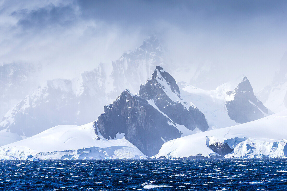Icebergs and mountains near Cuverville Island, Antarctica.